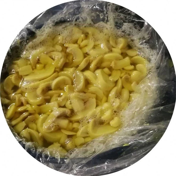 Good quality sliced white mushroom in salted water in drums